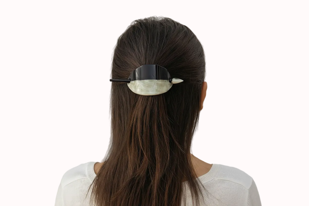 Person with a hair clip in their hair against a white background